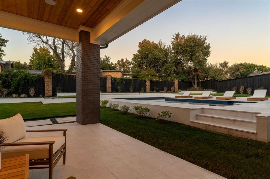 Fenced backyard featuring a patio and an outdoor pool