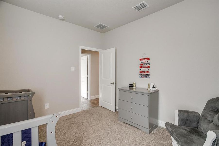 Bedroom featuring light colored carpet