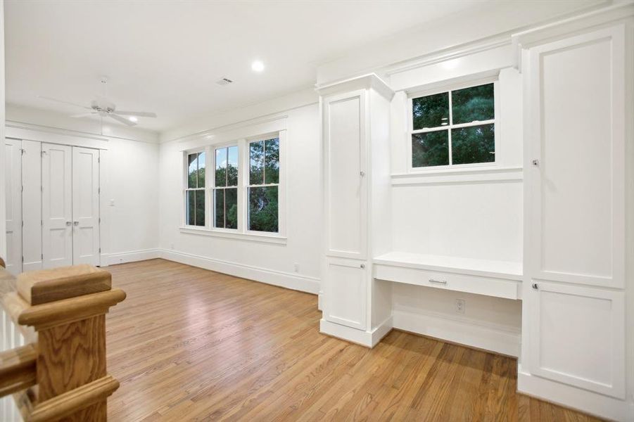 Another photo of the gameroom also shows the built in desk area with more storage. The gameroom looks out on to the front yard trees.