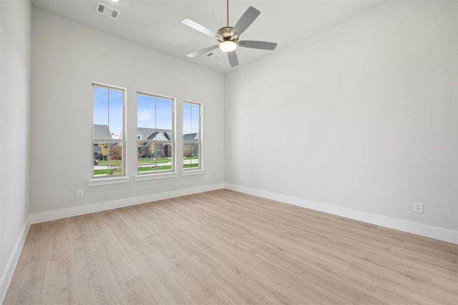 Unfurnished room with ceiling fan and light hardwood / wood-style floors