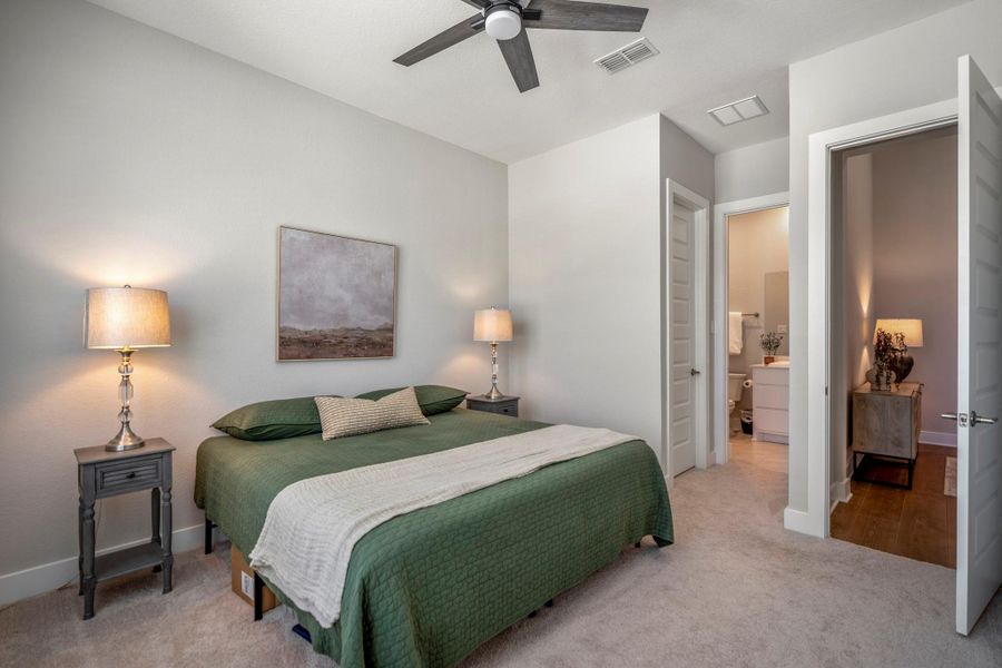 Overnight guests will feel right at home in this private first-floor suite with soft neutral carpet, a cooling ceiling fan, large walk-in closet and direct access to a private full ensuite bathroom.