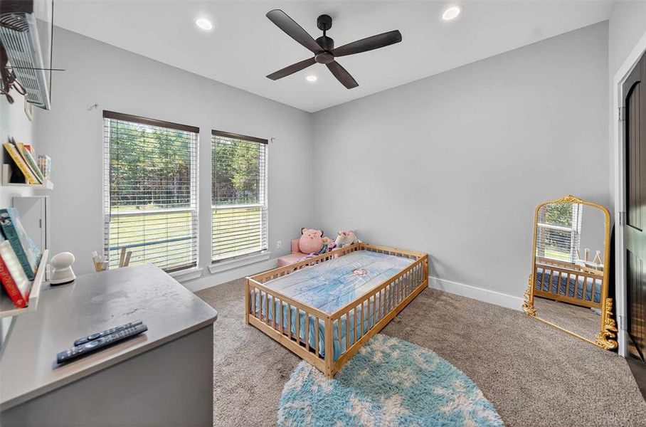 Bedroom featuring light colored carpet, ceiling fan, and recessed lighting Bedroom featuring light colored carpet, ceiling fan, and recessed lighting