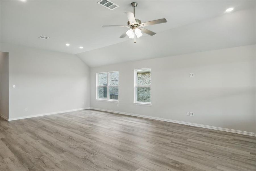 Unfurnished room featuring vaulted ceiling, baseboards, recessed lighting, a ceiling fan, and wood finished floors Unfurnished room featuring vaulted ceiling, baseboards, recessed lighting, a ceiling fan, and wood finished floors