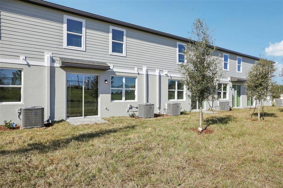 Exterior details and patio area of a home in The Reserve at Hammock Oaks Townes, Lady Lake (Image 3).