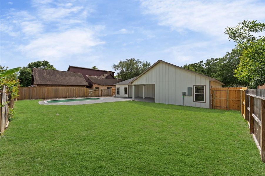 Even with a pool, and covered patio, this home also provides a very large lawn for other activities or gardening.