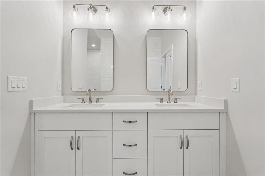 Full bath featuring double vanity