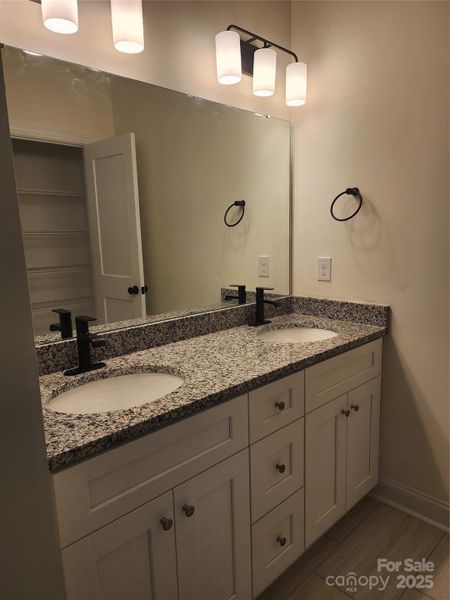 Double vanity with granite counters - primary bedroom en-suite