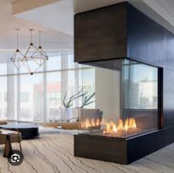 Example of Glass Enclosed Fireplace dividing Living Room from the Dining Room. Example of Glass Enclosed Fireplace dividing Living Room from the Dining Room.