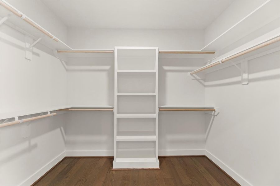 Very large walk in closet with custom built shelves
