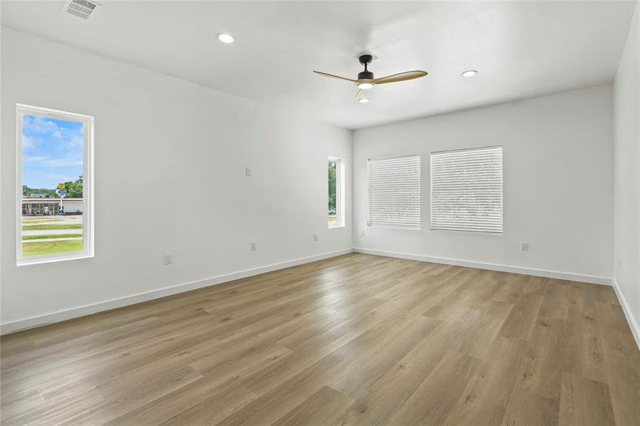 Spare room with a ceiling fan, light wood-style flooring, and recessed lighting Spare room with a ceiling fan, light wood-style flooring, and recessed lighting