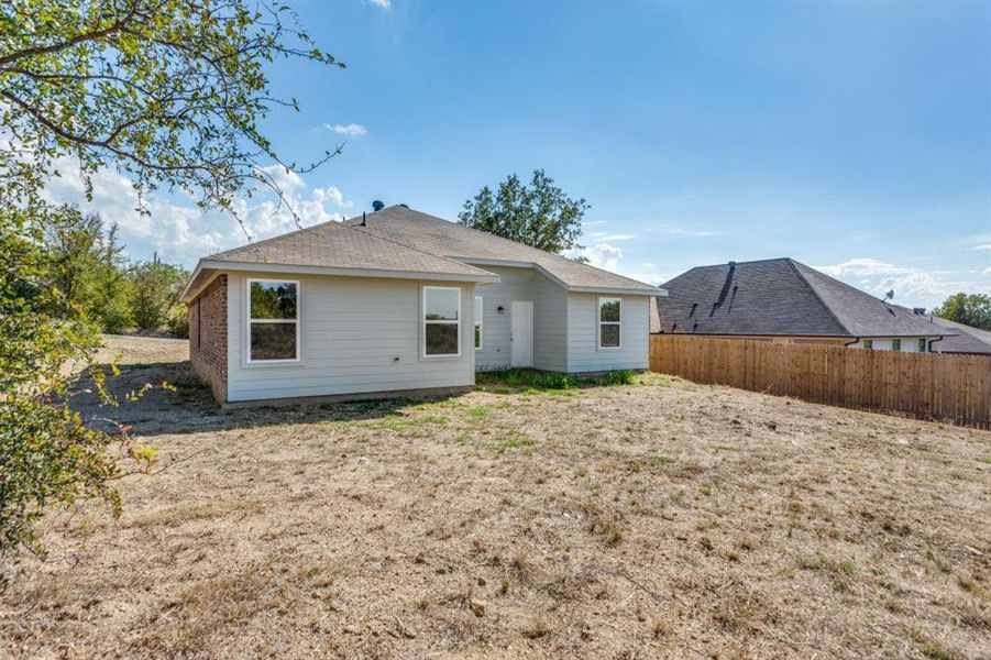 Rear view of property with roof with shingles