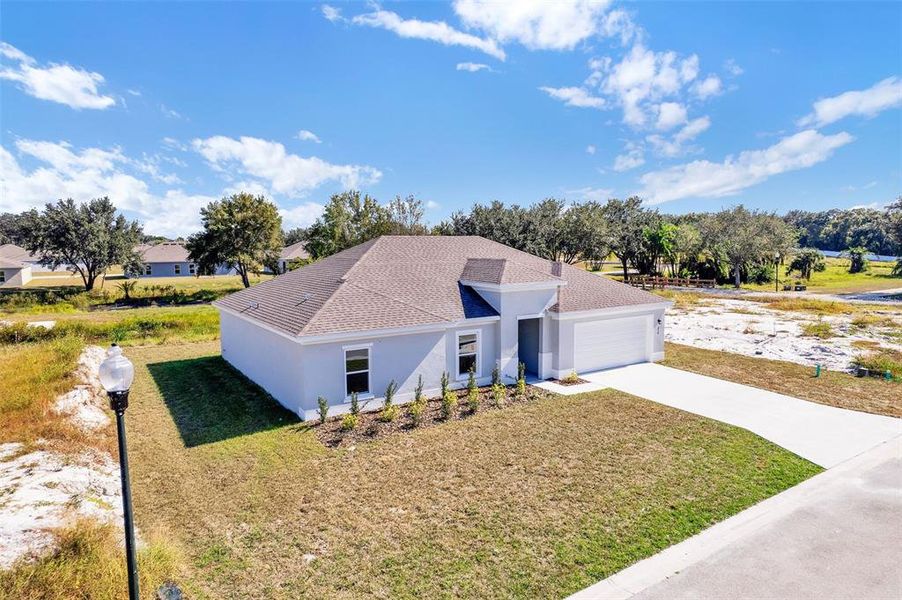 Front exterior of a new home in Grand Oaks, Avon Park, FL, highlighting curb appeal (Image 2).