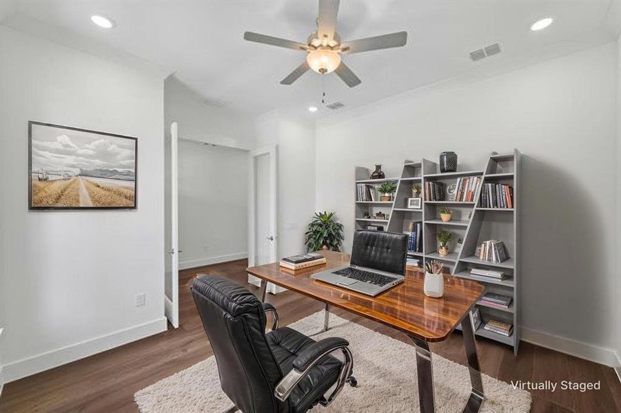 Bright room with dark wood-finish flooring, recessed lighting, and a ceiling fan