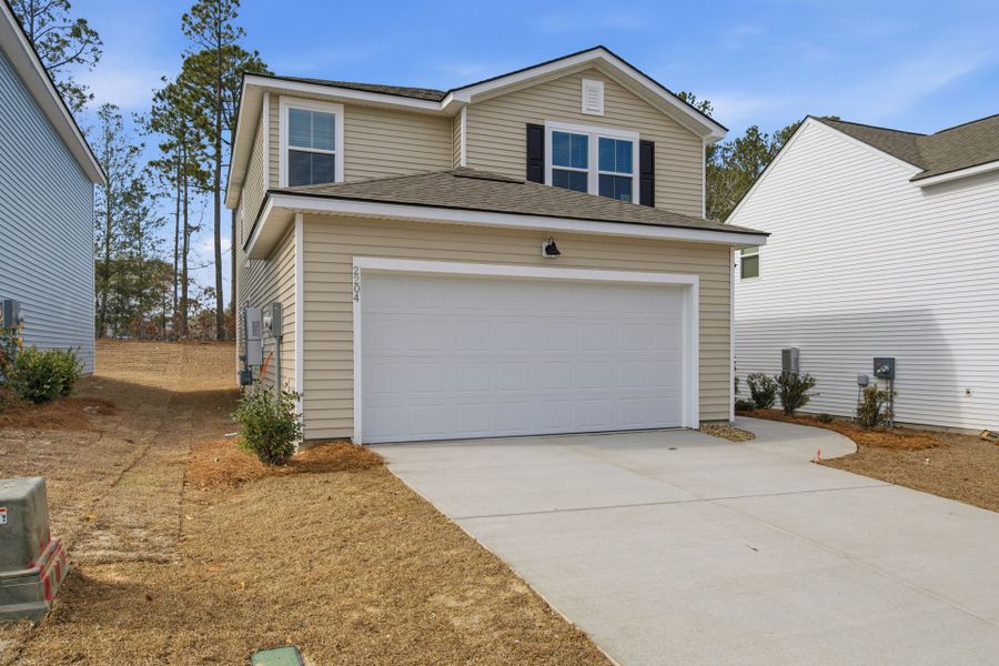 Front exterior of a new home in Grand Arbor, Blythewood, SC, highlighting curb appeal (Image 2). Front exterior of a new home in Grand Arbor, Blythewood, SC, highlighting curb appeal (Image 2).