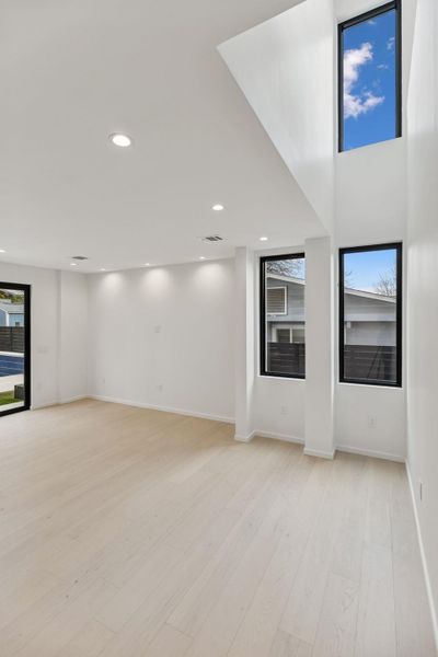 Unfurnished living room with light wood-type flooring and recessed lighting