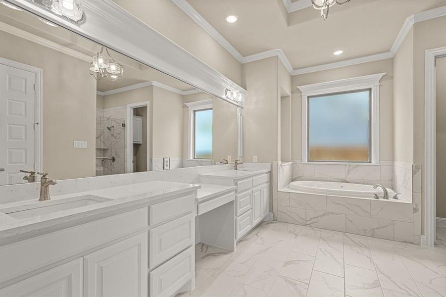 Bathroom featuring crown molding, dual bowl vanity, tiled tub, and tile patterned flooring