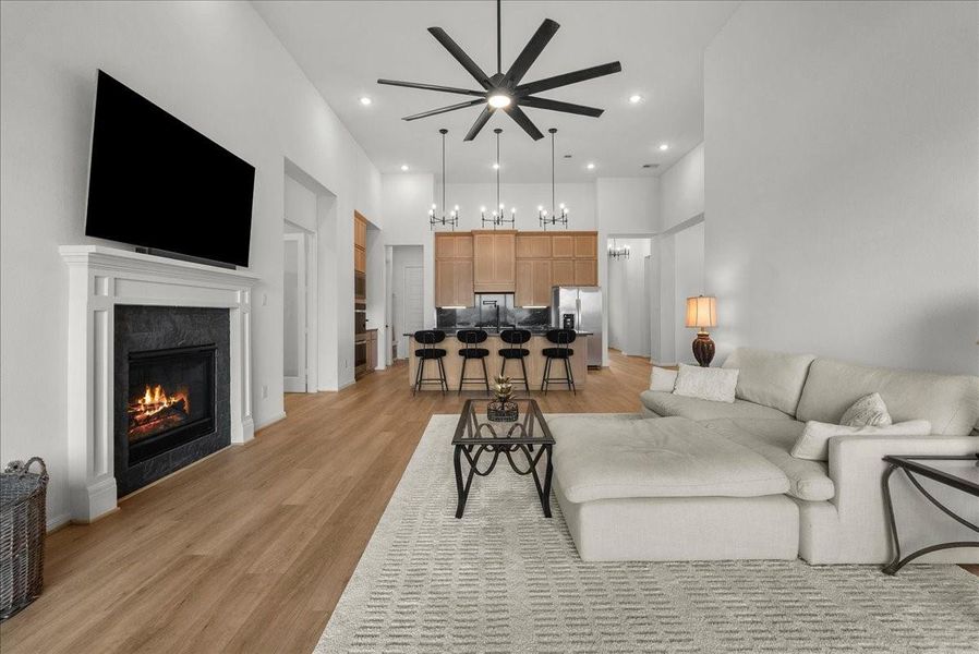 Living room showcases soaring ceilings, a cozy fireplace, and breathtaking water views.