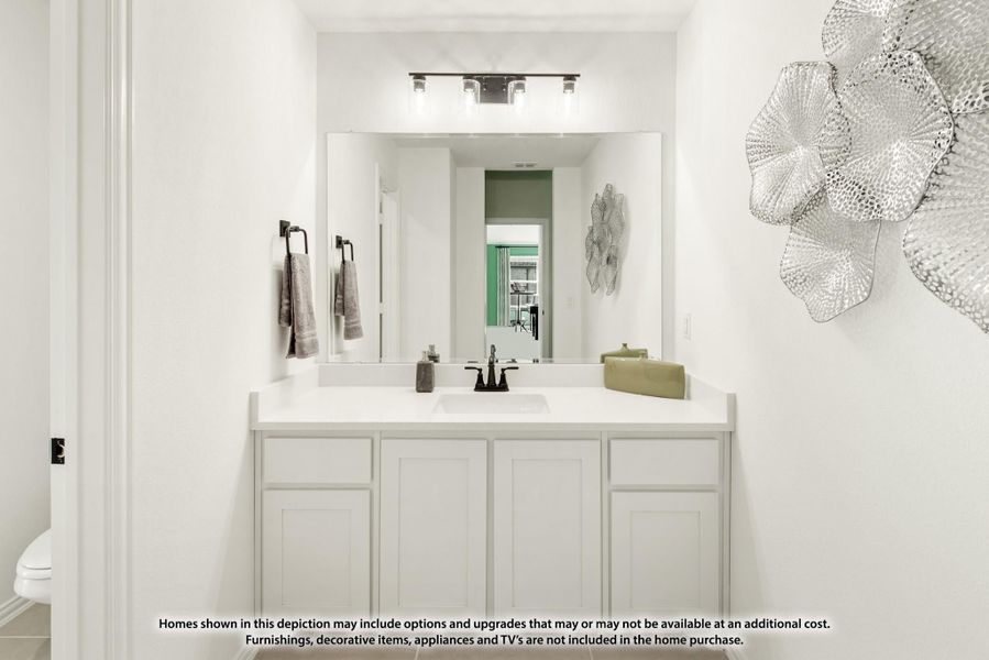 Bathroom vanity with white cabinets, white countertop, large mirror, and three-bulb light fixture above Bathroom vanity with white cabinets, white countertop, large mirror, and three-bulb light fixture above