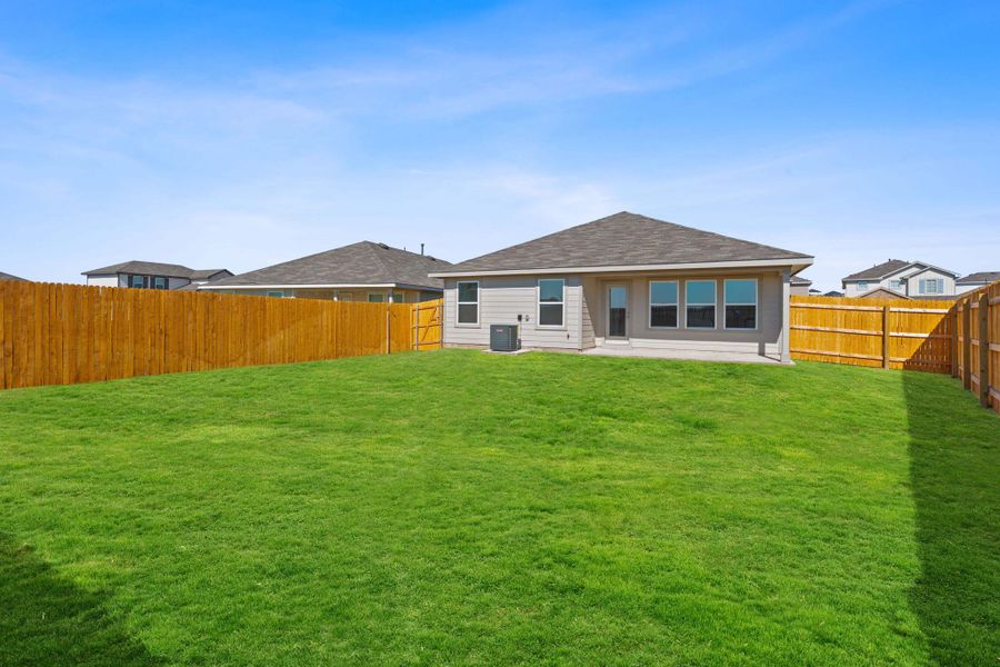 Rear view of property with a patio, a fenced backyard, and roof with shingles