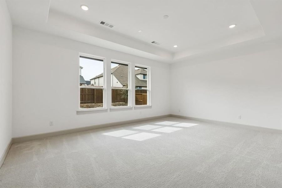 Plush carpeting, a neutral color palette, high ceilings and a wall of windows create an owner's suite where rest and relaxation are king!