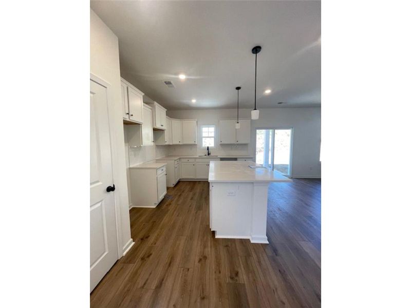 This kitchen features a central island, ample cabi