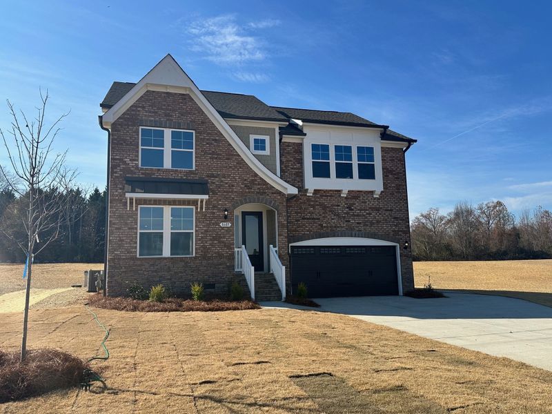 Front exterior of a new home in Lilah Grove, Summerfield, NC, highlighting curb appeal (Image 1).