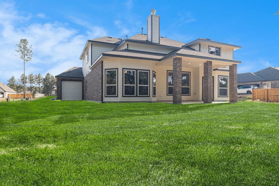 Front exterior of a new home in Deer Pines, Conroe, TX, highlighting curb appeal (Image 2).