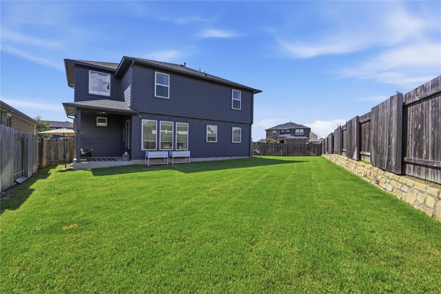 A spacious backyard provides ample green space for outdoor activities and entertaining.