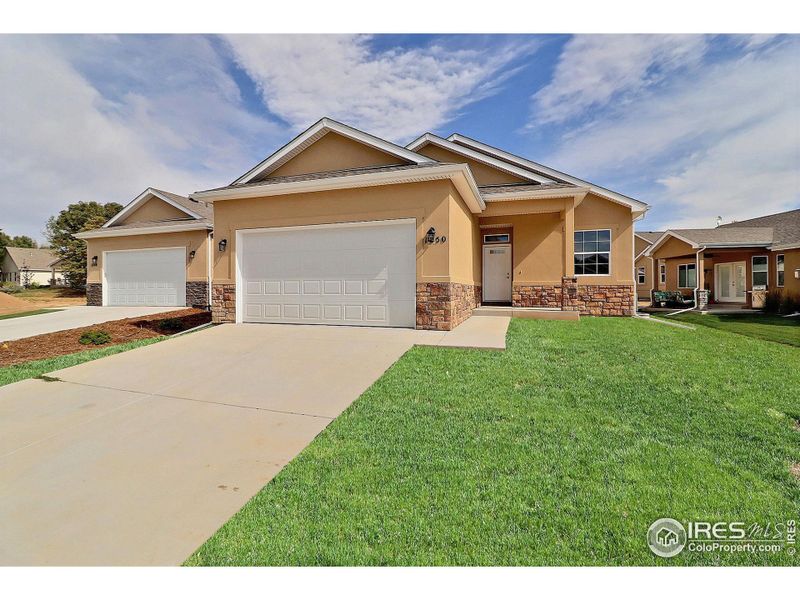 Stucco home with landscaping included