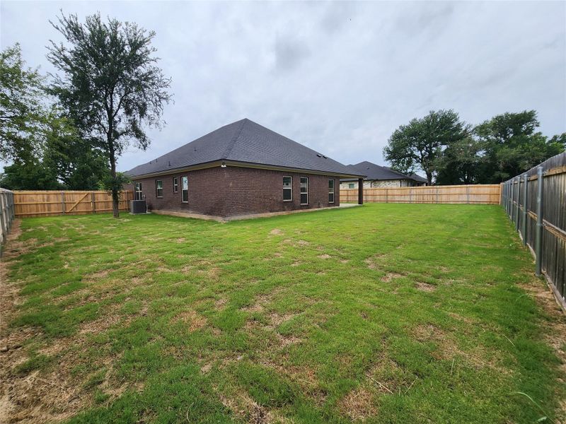 A fully fenced yard offers a private outdoor retreat for leisure and recreation. A fully fenced yard offers a private outdoor retreat for leisure and recreation.