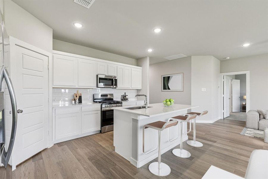 Kitchen in the Harper home plan by Trophy Signature Homes – REPRESENTATIVE PHOTO