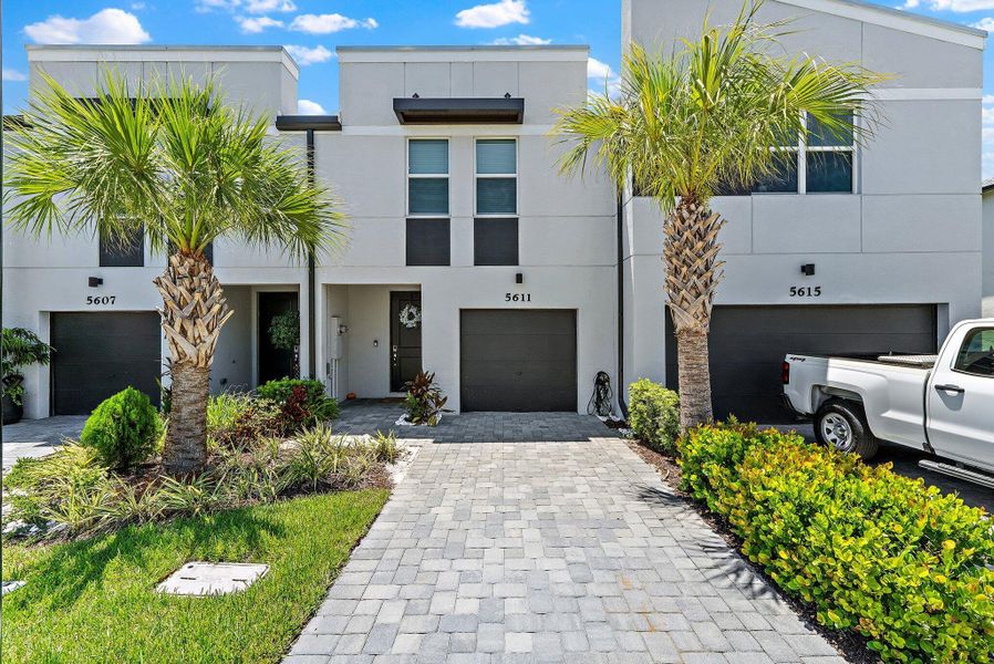 Front exterior of a new home in Enclave at Mangonia Park, West Palm Beach, FL, highlighting curb appeal (Image 21).