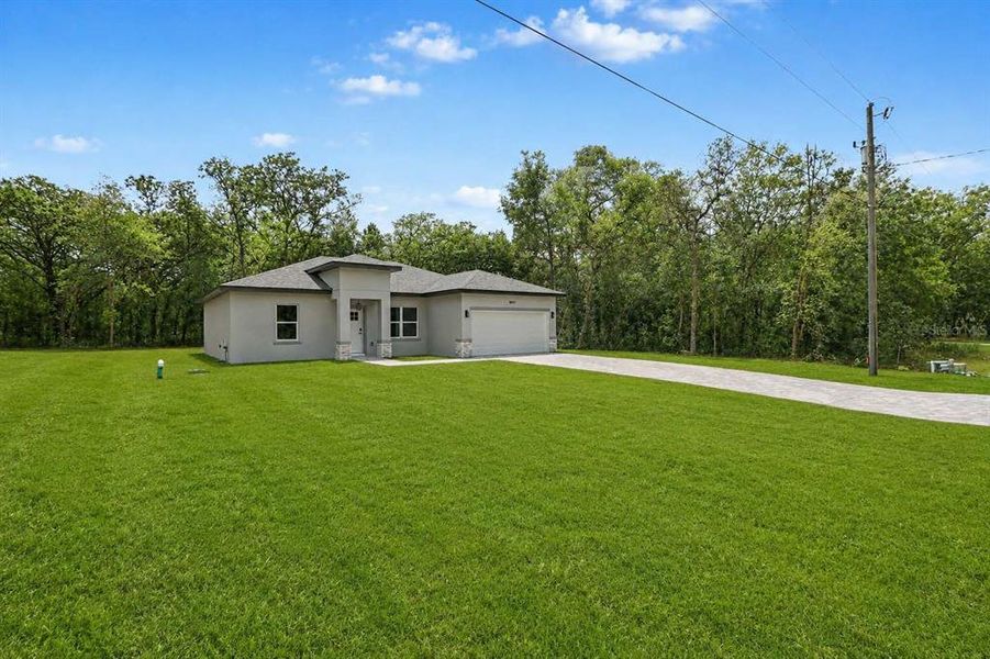 Front exterior of a new home in , Citrus Springs, FL, highlighting curb appeal (Image 21).