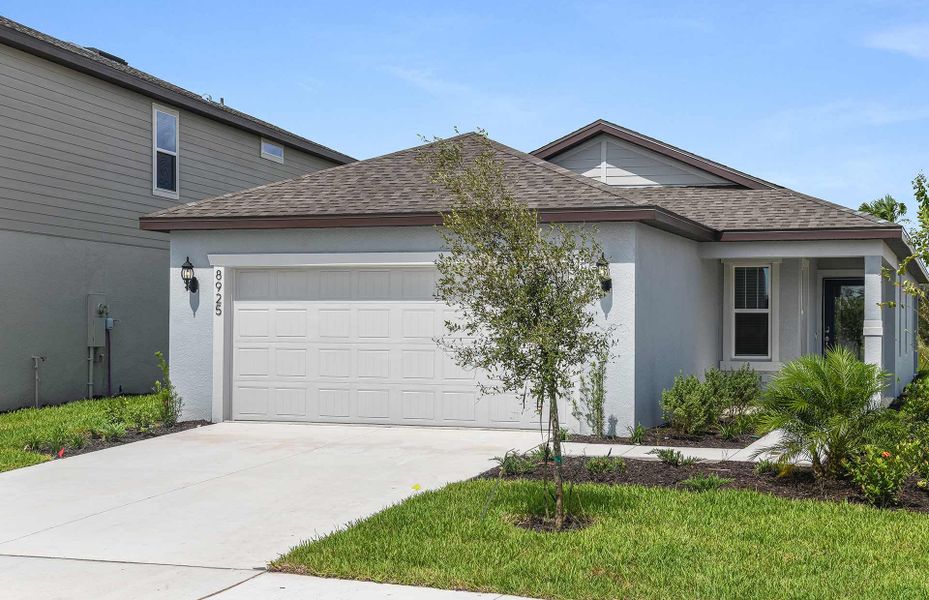 Front exterior of a new home in Oakfield Lakes, Parrish, FL, highlighting curb appeal (Image 1). Front exterior of a new home in Oakfield Lakes, Parrish, FL, highlighting curb appeal (Image 1).
