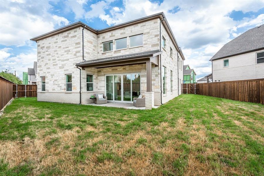 Back of property with a patio area and a yard