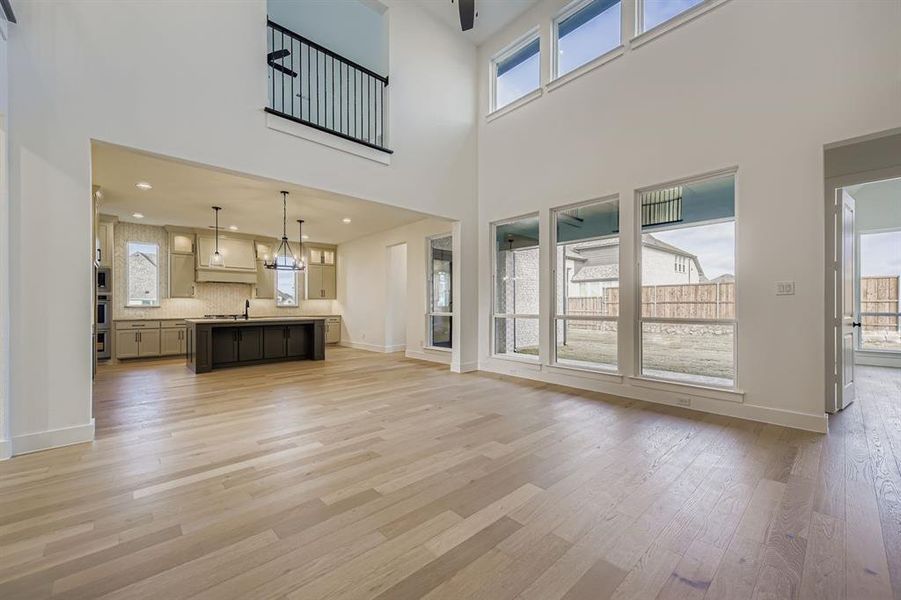 Unfurnished living room with healthy amount of natural light and light wood-style flooring