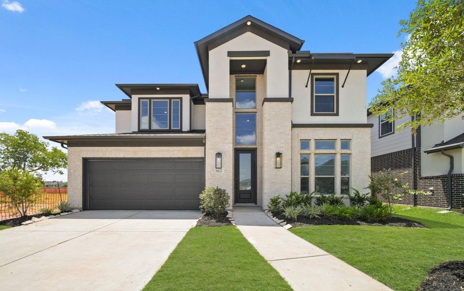 Front exterior of a new home in Sienna Village of Anderson Springs 50', Missouri City, TX, highlighting curb appeal (Image 2). Front exterior of a new home in Sienna Village of Anderson Springs 50', Missouri City, TX, highlighting curb appeal (Image 2).