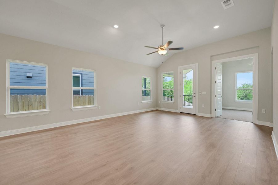 Unfurnished living room with a ceiling fan, light wood-style flooring, vaulted ceiling, and recessed lighting Unfurnished living room with a ceiling fan, light wood-style flooring, vaulted ceiling, and recessed lighting