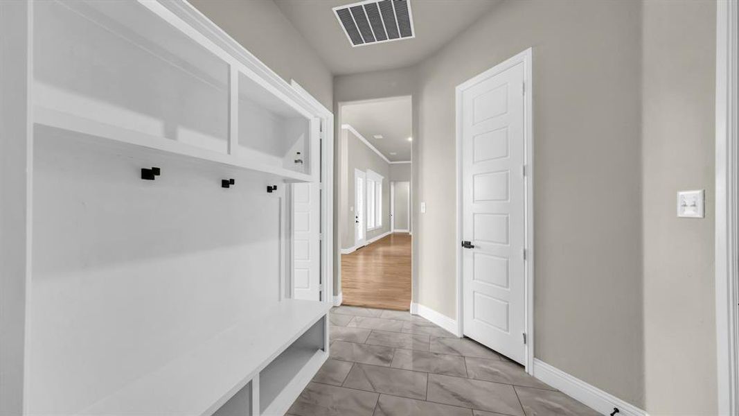 Mud room is equipped with custom built ins for your daily wear of jackets and shoes.