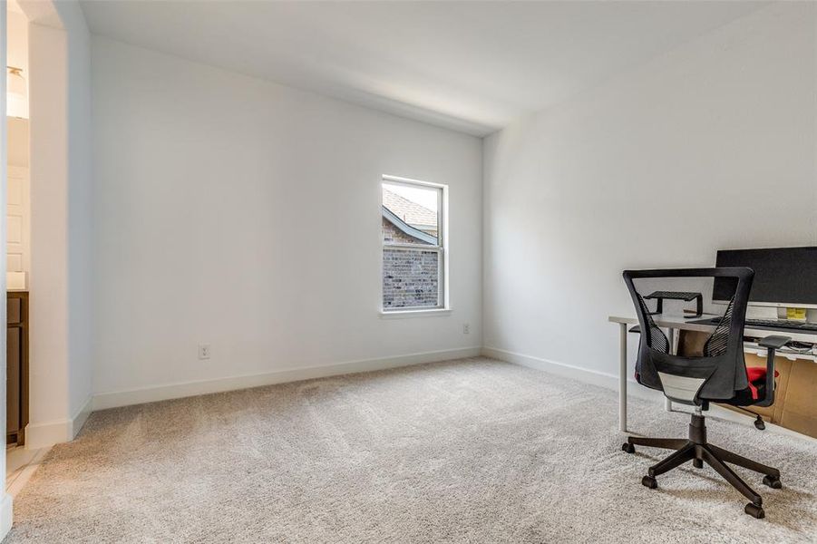 Unfurnished office with light colored carpet and baseboards