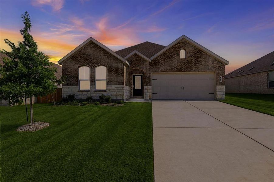 Brick facade home with stone accents, a two-car garage, and an arched front entry window Brick facade home with stone accents, a two-car garage, and an arched front entry window