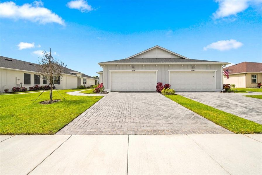 Front exterior of a new home in The Timbers at Everlands, Palm Bay, FL, highlighting curb appeal (Image 26).