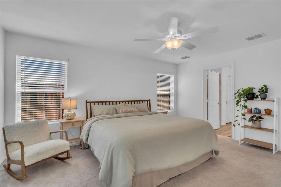 Bedroom with light carpet and ceiling fan