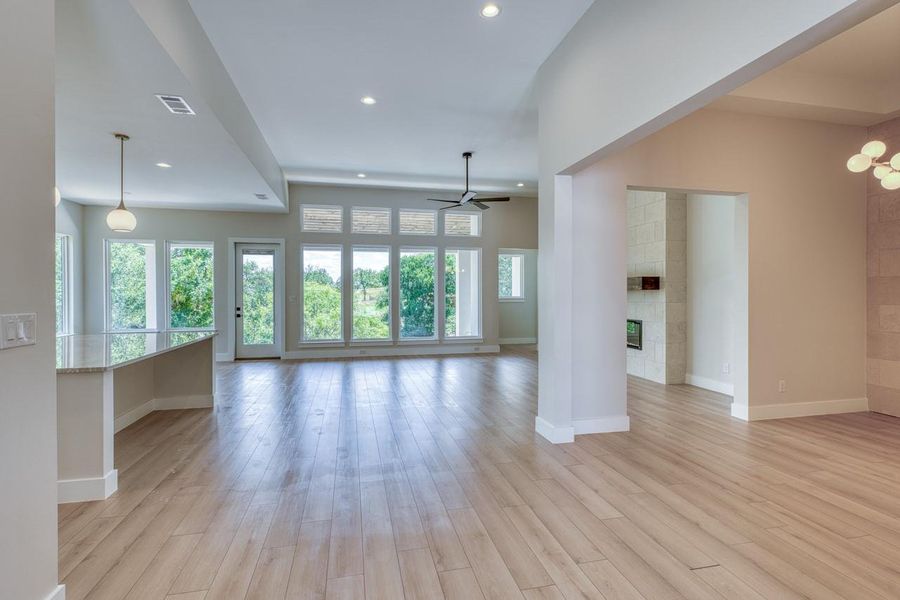 A spacious, naturally illuminated interior with high ceilings and verdant views invites relaxation.