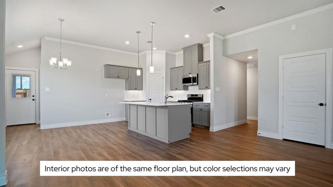 The kitchen island has beautiful and durable quartz countertops and a farmhouse sink.