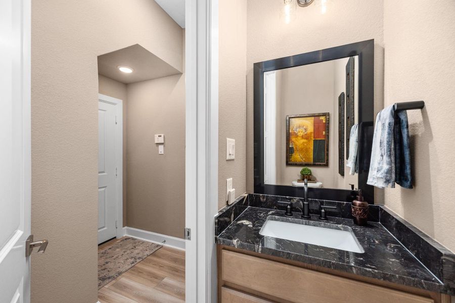 Elegant half bath with exquisite finishes was added instead of a closet