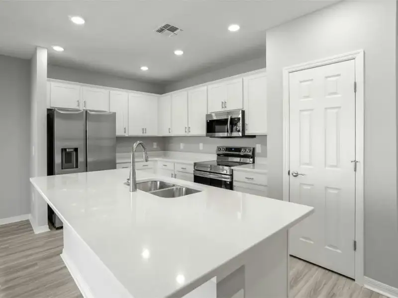 Your island kitchen includes 36-inch cabinets, quartz countertops, Samsung SS appliances, and a pantry.