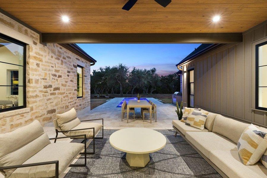 An inviting covered patio seamlessly blends indoor comfort with outdoor leisure by the pool.