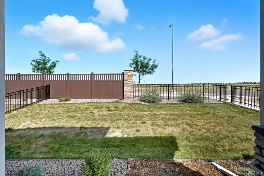 Private, fenced, side yard with sprinklers