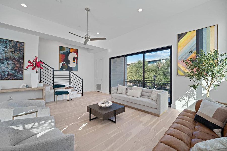 Living area with light wood-style flooring, recessed lighting, stairs, and a ceiling fan
